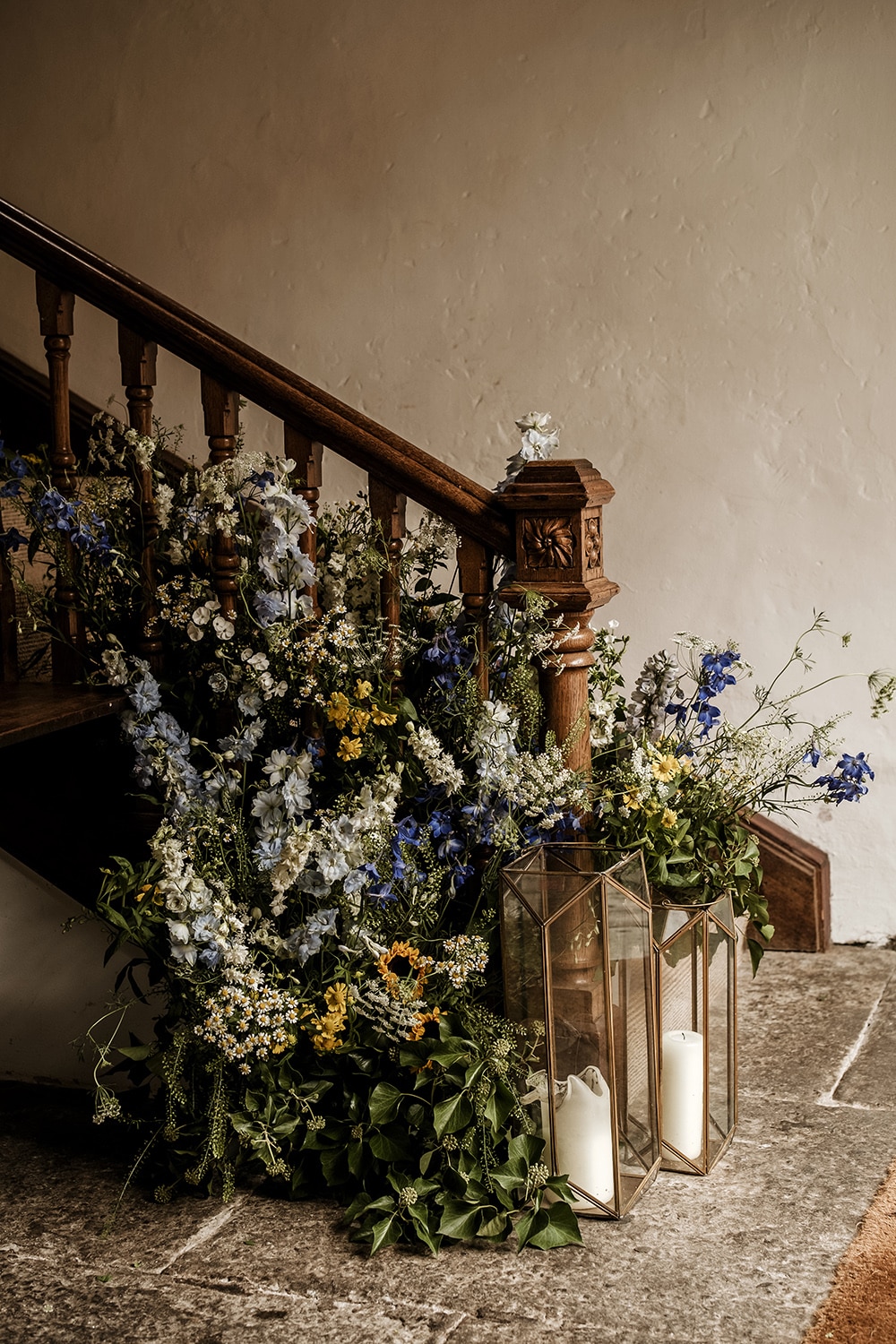 Wedding flowers at the base of the main staircase at penned house