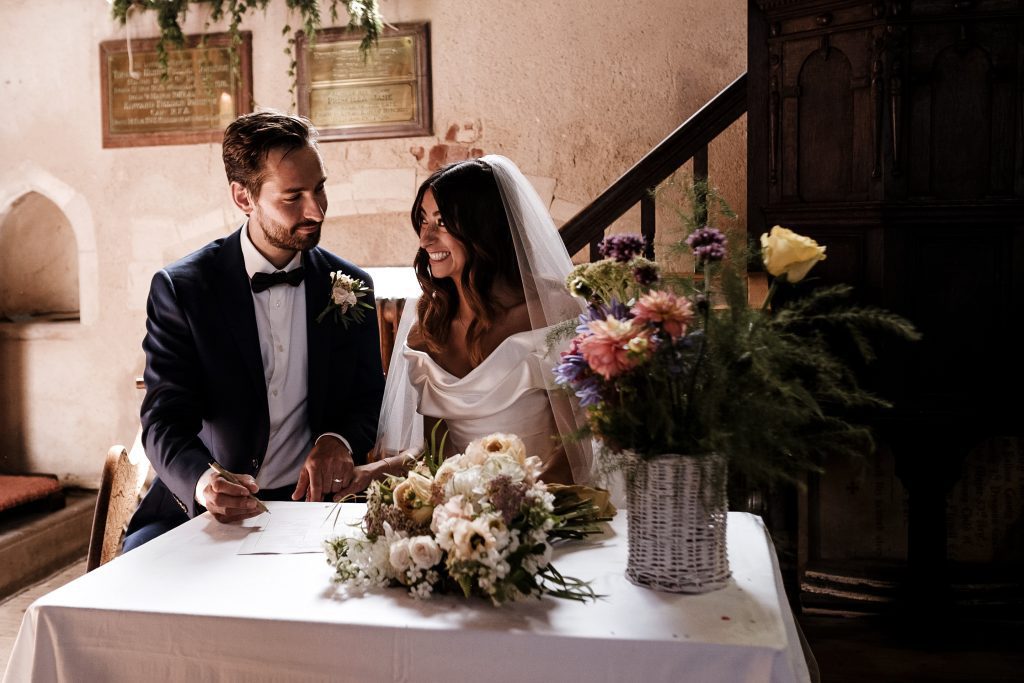 wedding photographer capturing the signing of the register