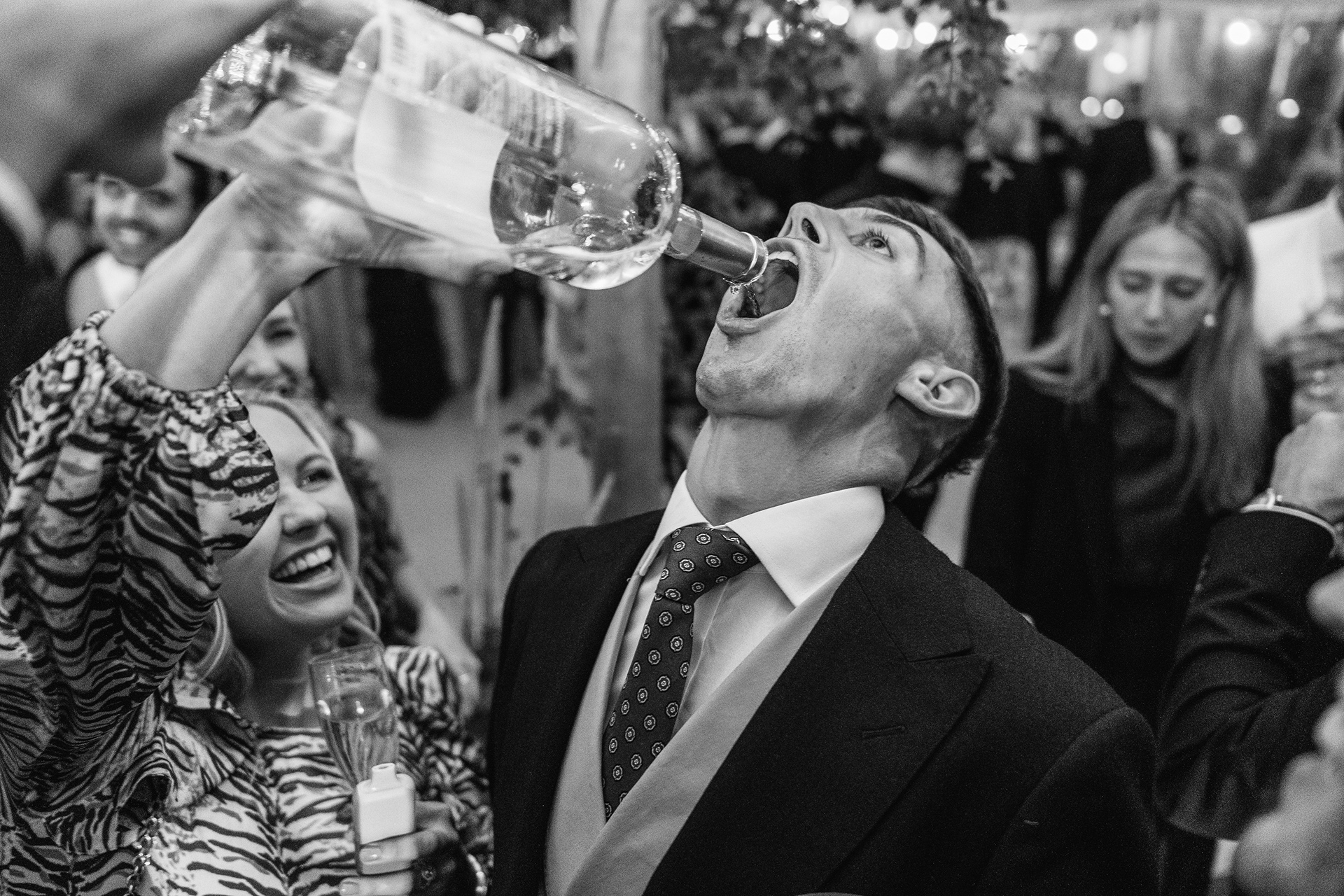 pouring wine in to someones mouth