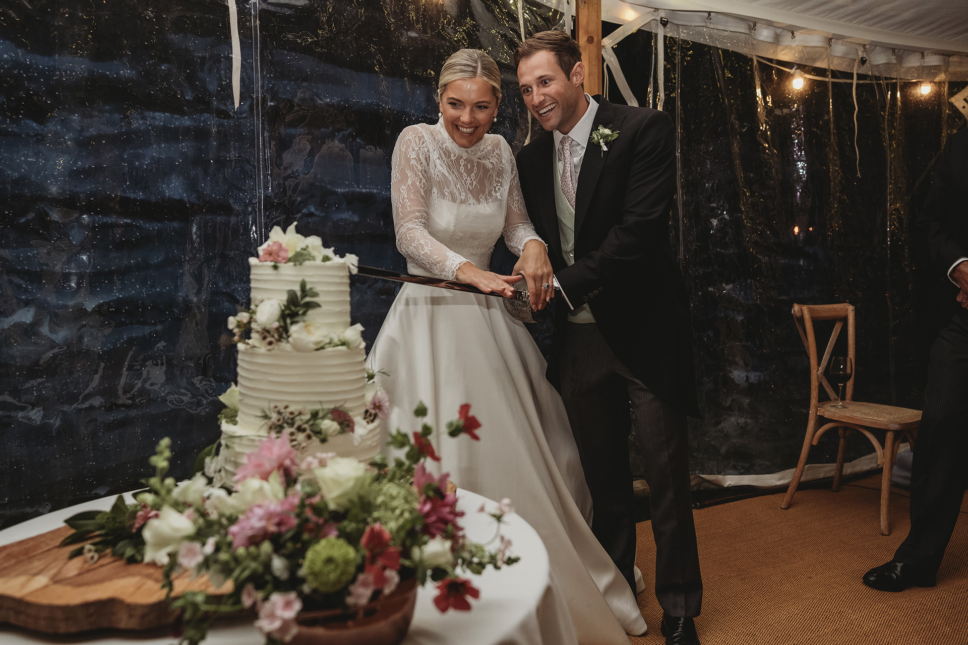 cutting the wedding cake with a sword