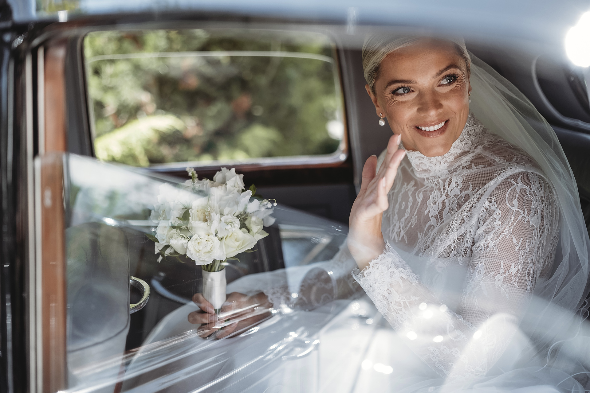 very regal bride waving to parents leaving house