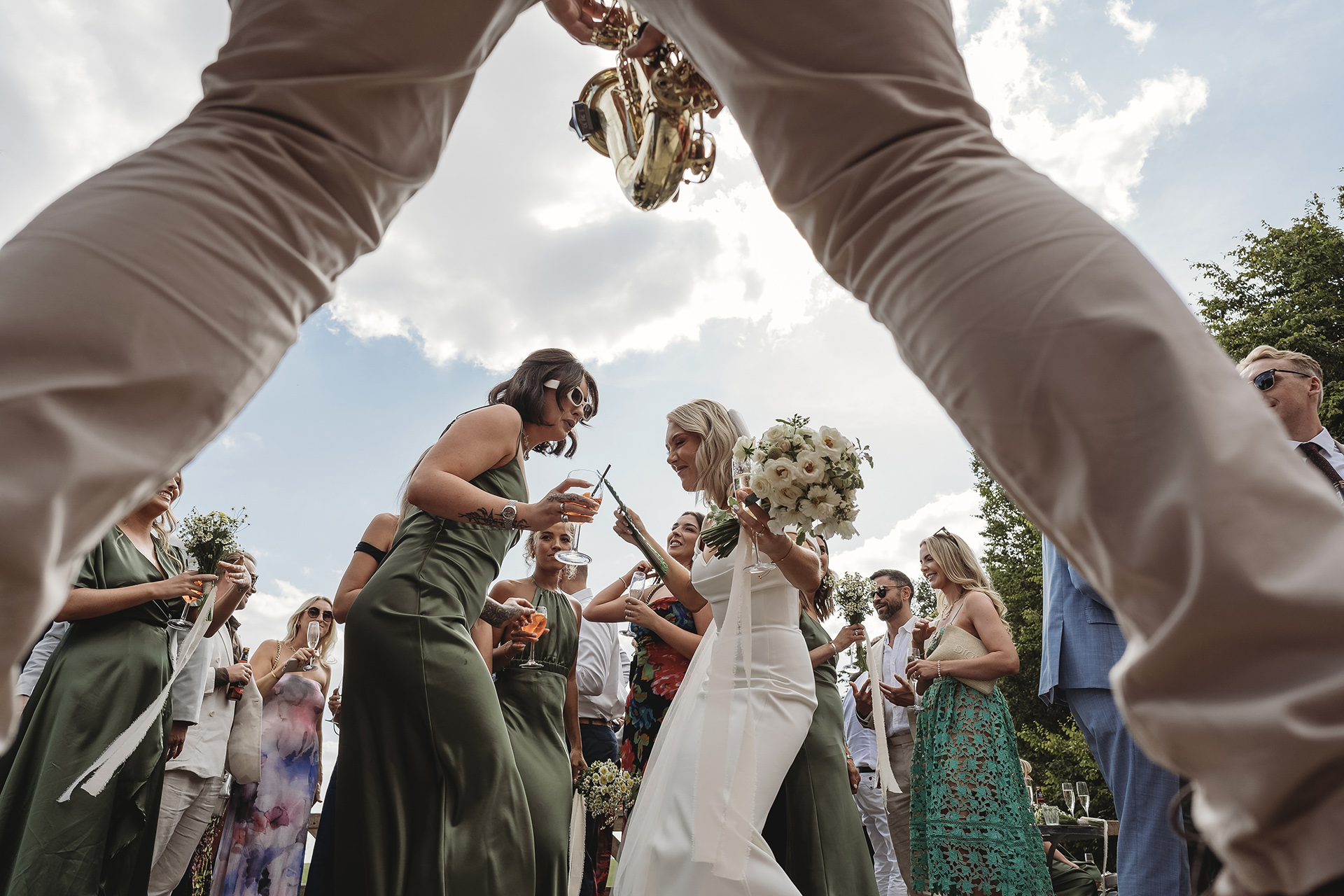 bride dancing between saxophonist legs