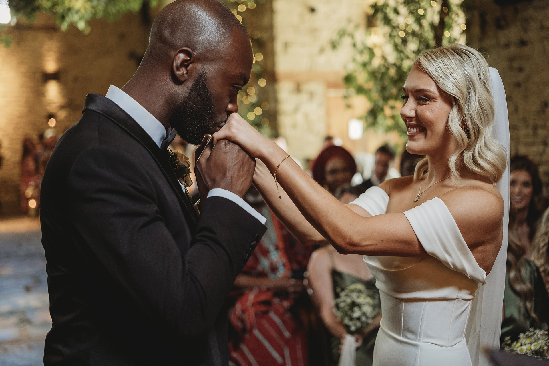 groom kissing brides hands